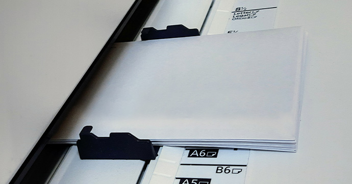 Envelopes in a printer tray.