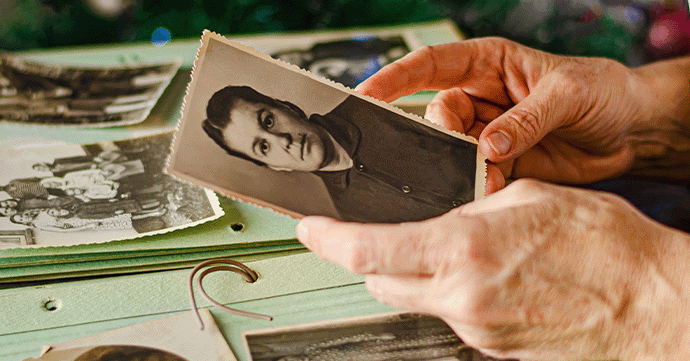 Holding an old photo.