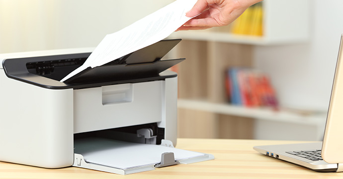 Holding paper near a laser printer.