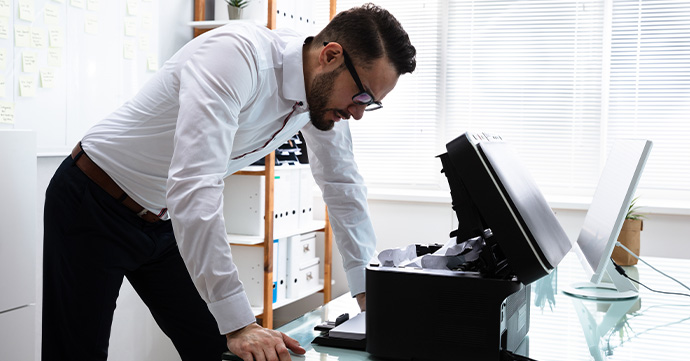Person annoyed by a printer.