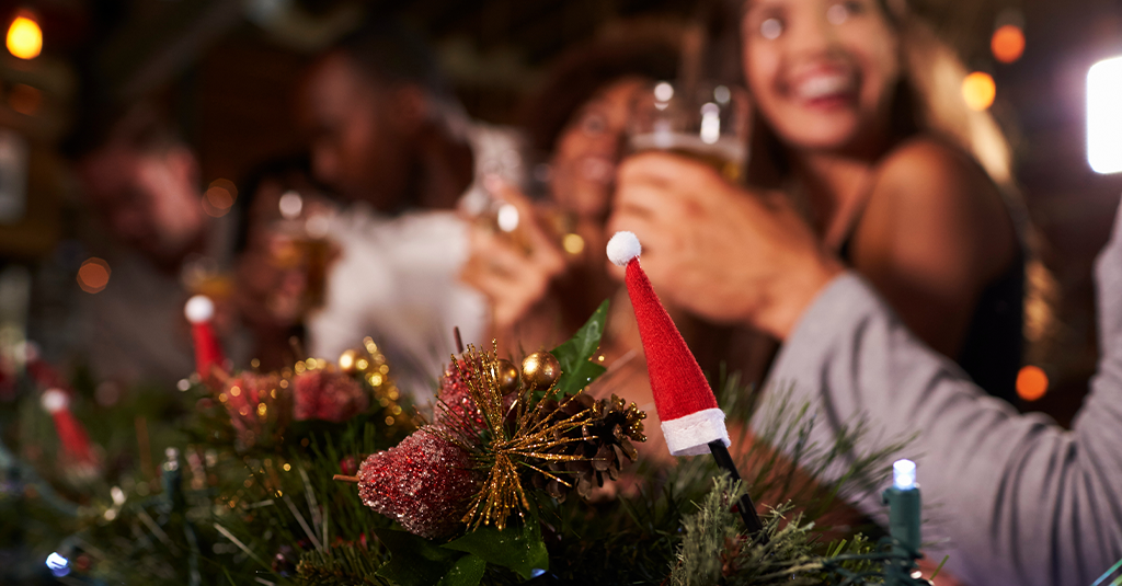 Festive table decorations with partygoers in soft focus.