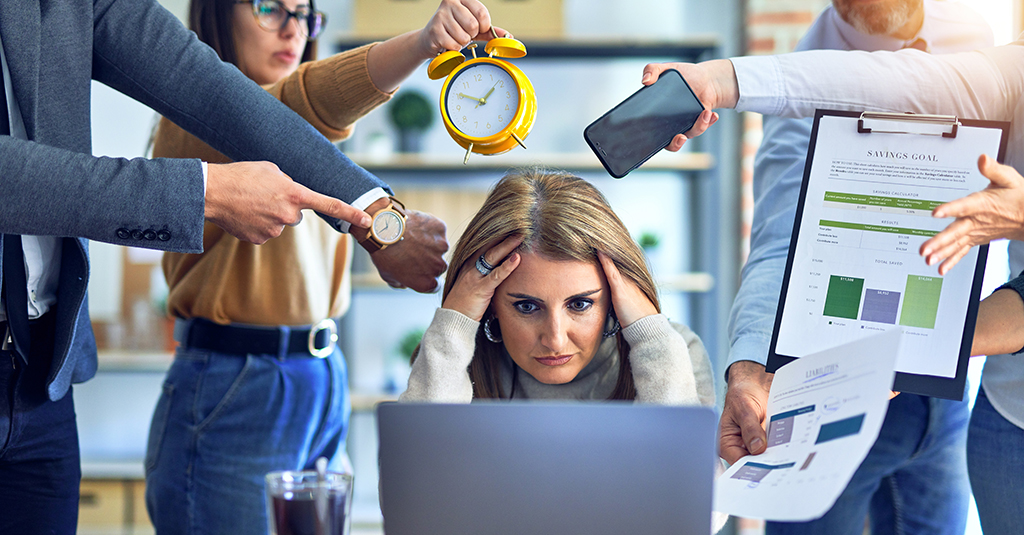 Distracted office worker surrounded by colleagues