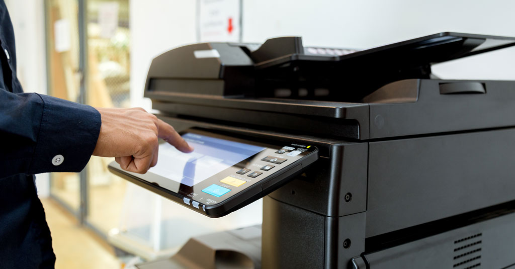 Person using a touchscreen on a laser printer.